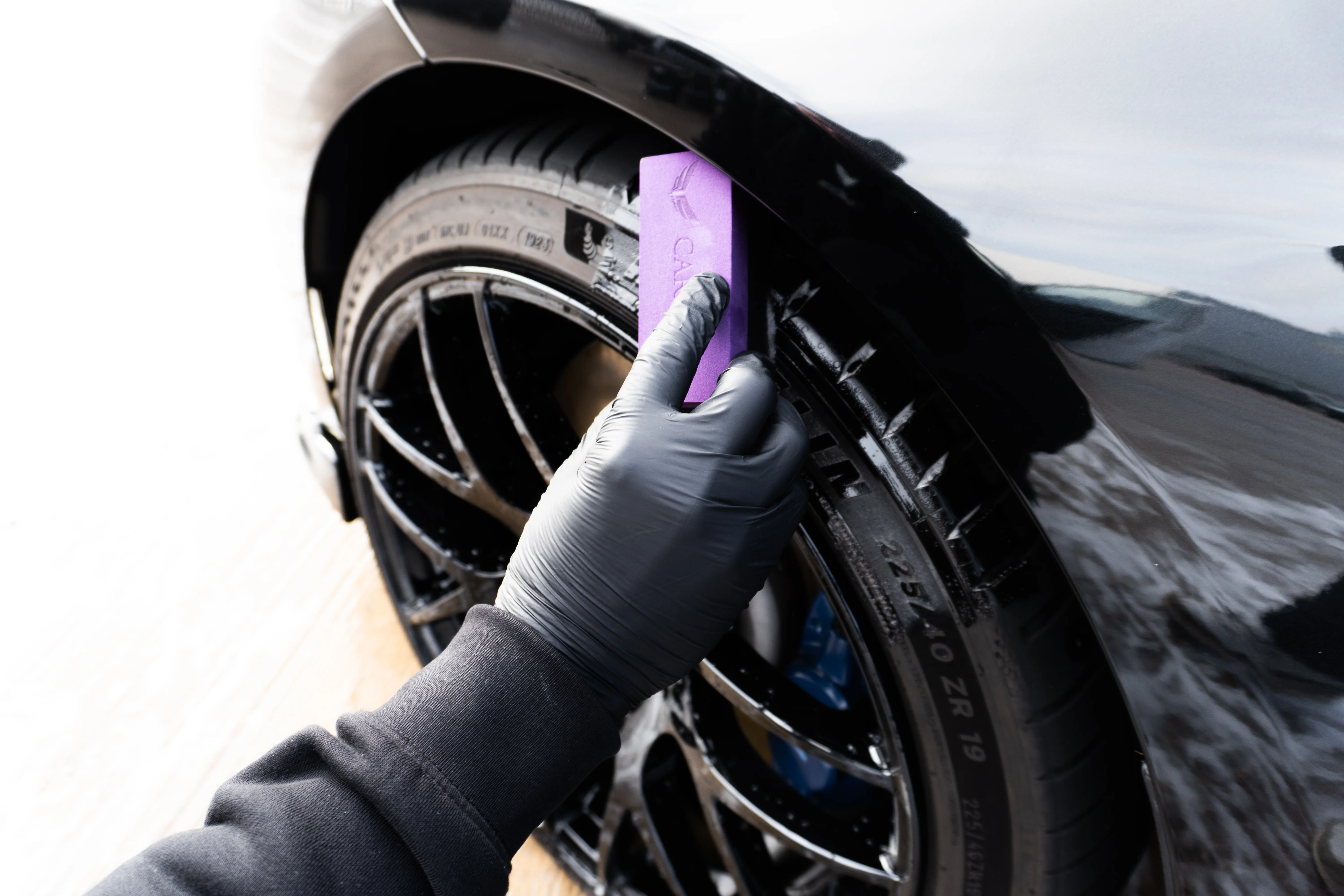 Professional car detailing with careful exterior cleaning and paint finishing