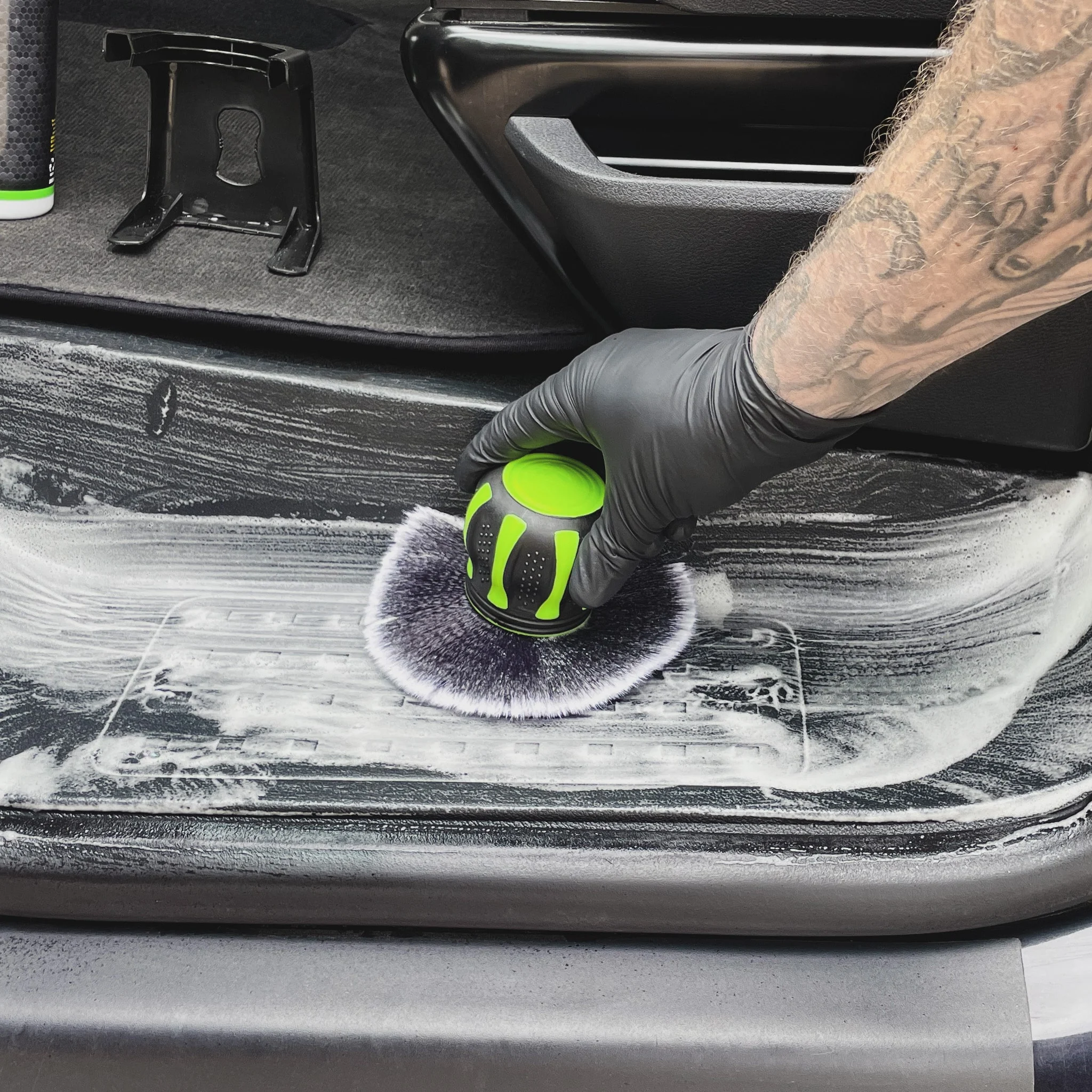 Car detailing specialist carefully cleaning a vehicle interior